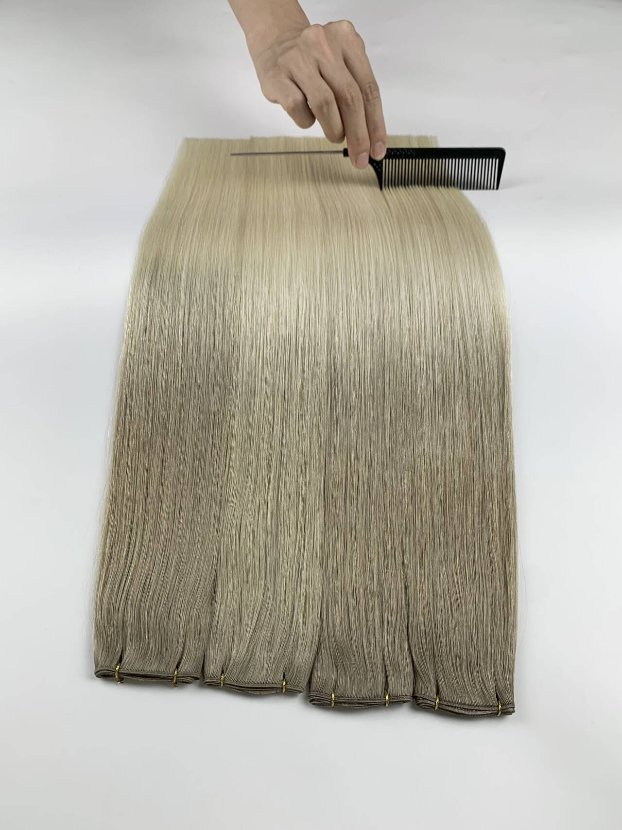 Hair being combed during a careful quality inspection