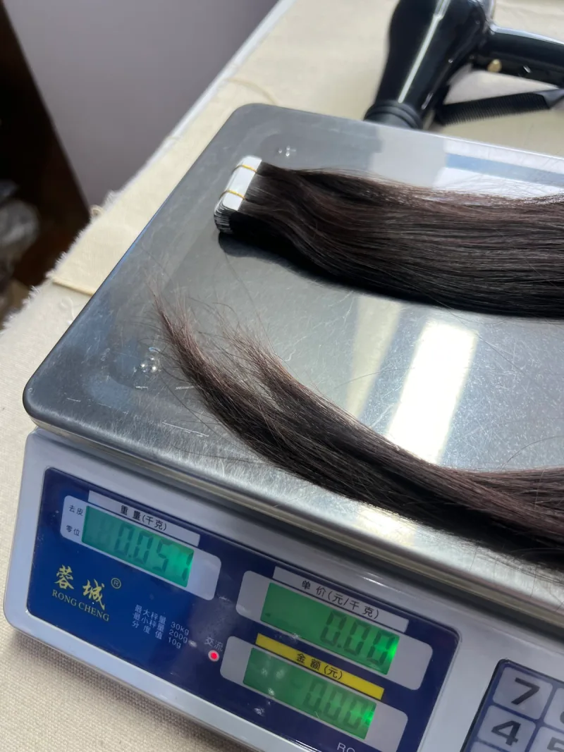 Tape-In on a factory scale displaying 0.051kg, equivalent to 51g