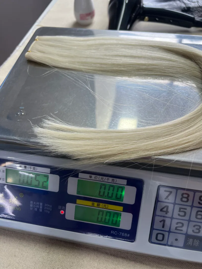 Genius Weft on a factory scale displaying 0.052kg, equivalent to 52g